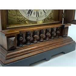 Late 19th century walnut architectural cased mantel clock, the brass dial with silvered Roman chapter ring enclosed by glazed door with reeded columns, split turned balustrade frieze, on stepped plinth base, twin train eight day movement striking on coil