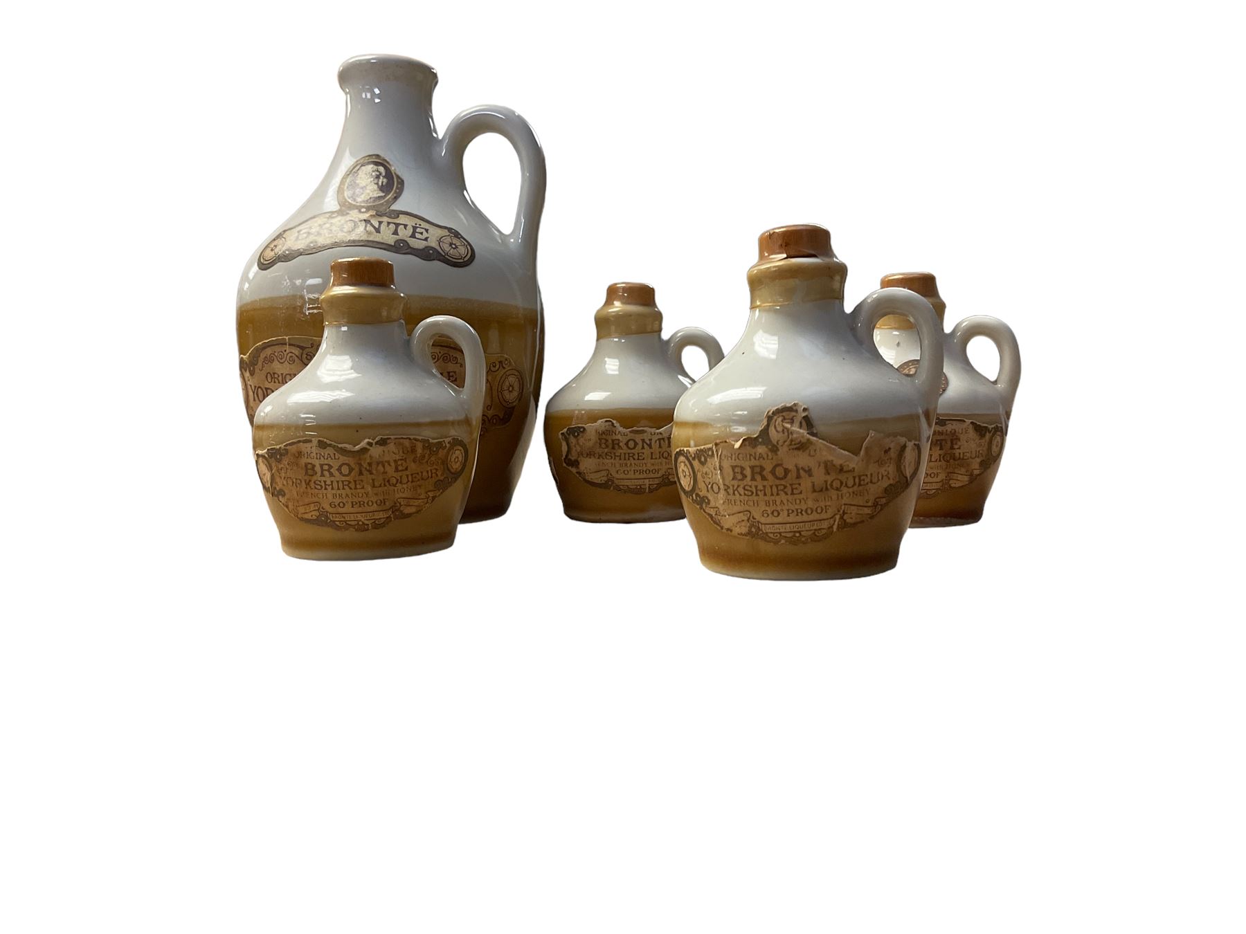 Four glass decanters, together with an empty Bronte Yorkshire Liqueur flagon and four miniatures 