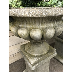  Pair large composite stone twin handled garden urns on square column plinths (planted), W74cm (including handles), H118cm  