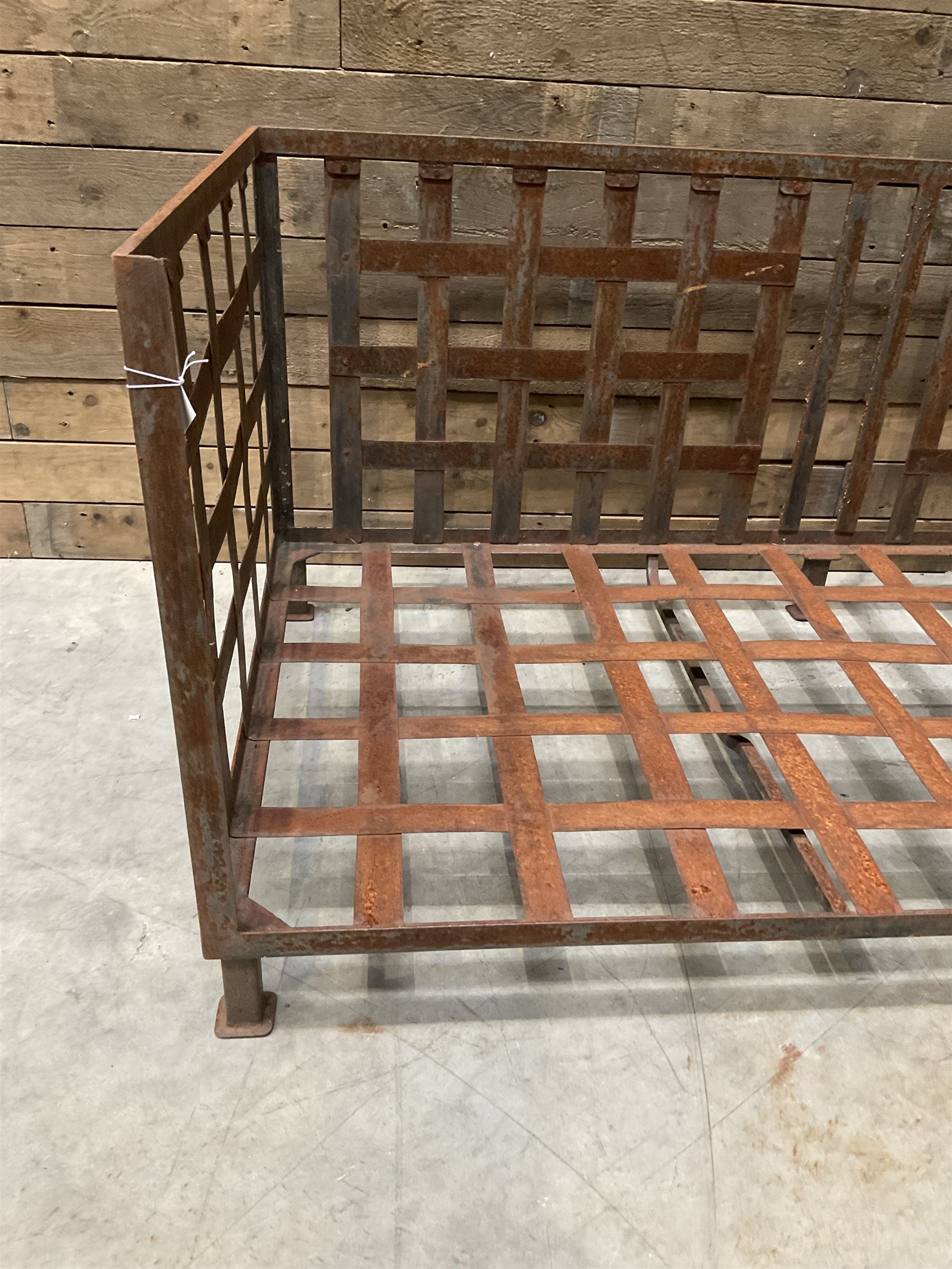 Wrought iron strapwork garden day bed, lattice back and sides