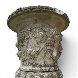 Pair of quality antique weathered three-piece composite stone garden urns, the flared rim moulded with repeating acanthus leaves, over a deep-relief campana body decorated with fruiting grapevines and ivy leaves, the gadrooned underbelly over a turned socle and square base