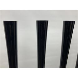 Six tall tapering cylindrical black glass vases, each with fluted rims, H90cm