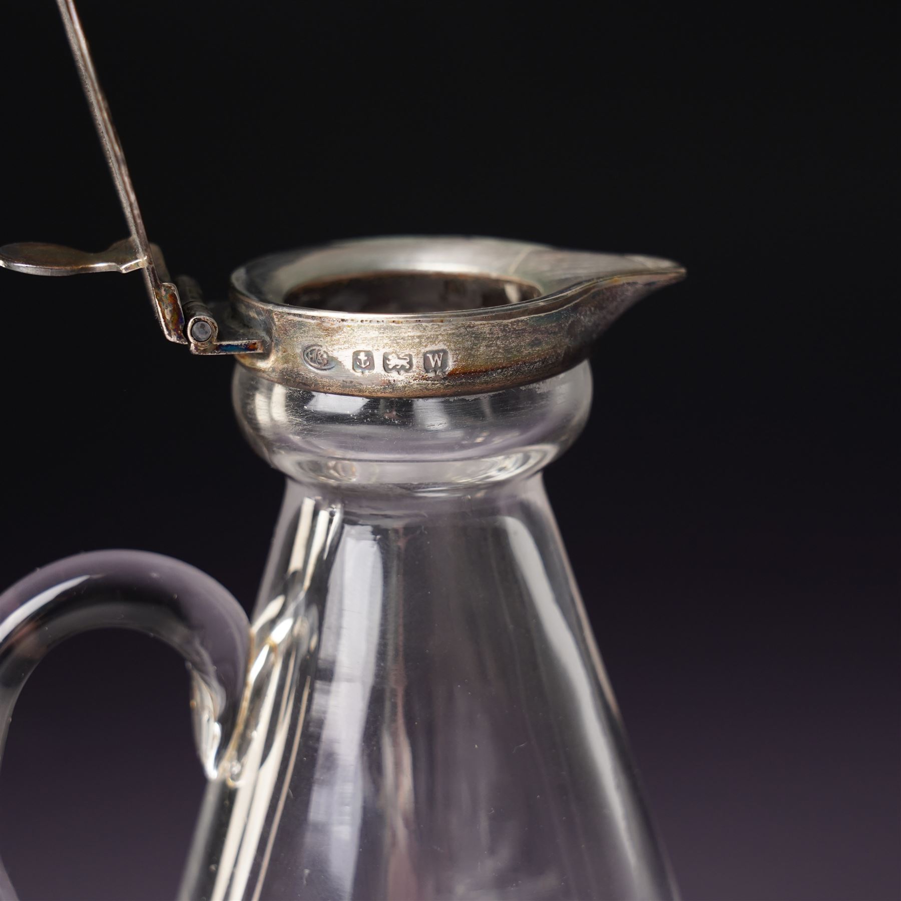 Glass whisky noggin with silver hinged cover and clear glass handle H10cm Birmingham 1921 Maker Hukin & Heath, a pair of early silver decanter labels 'Lisbon' and 'Port' and a small silver frame 