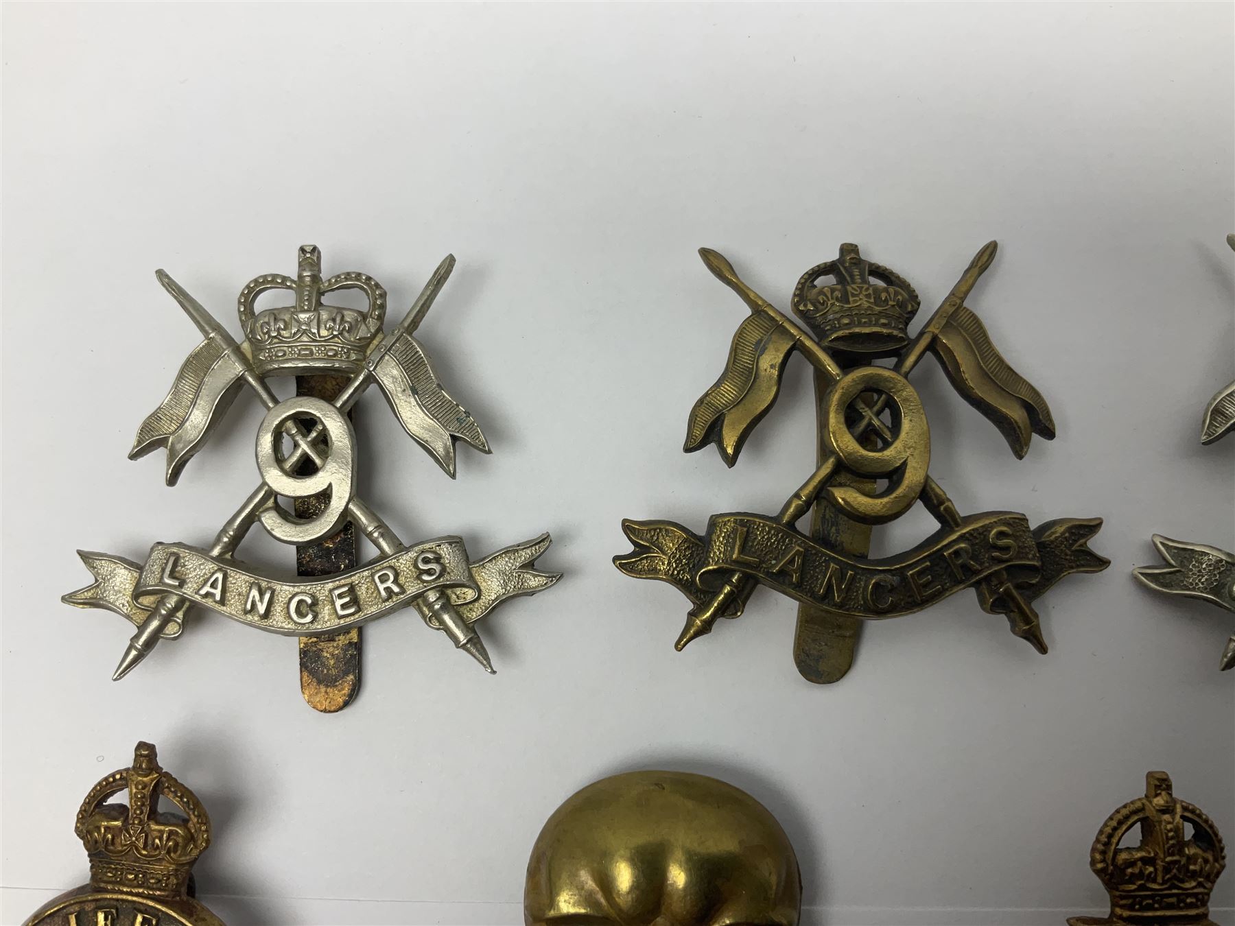 Nine Lancers metal cap badges including 9th, 12th Royals, 24th, 16th Queens and 17th; together with eight various Guards/Dragoons badges (17)