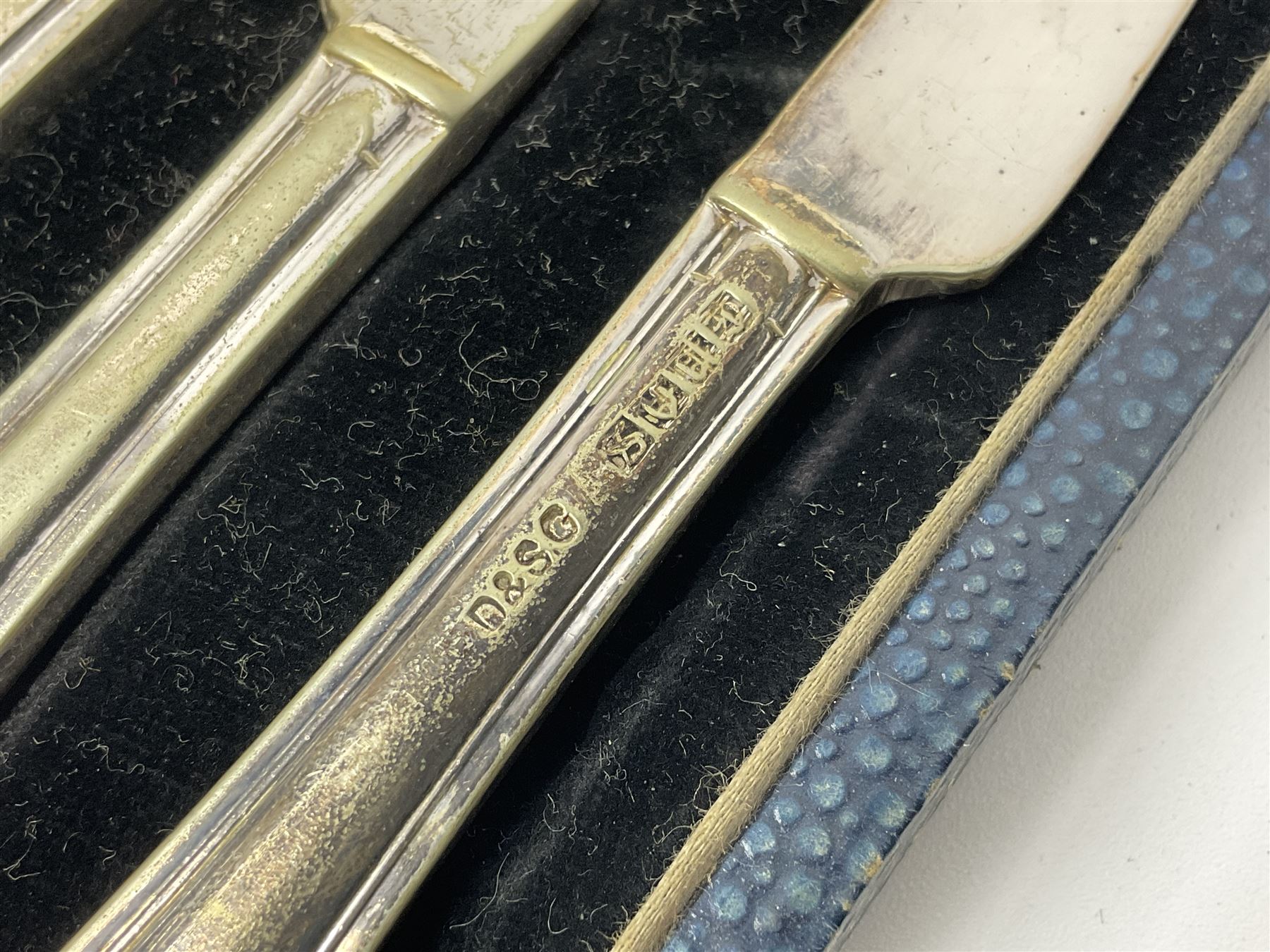 Set of six stag horn handled knives by Cooper Brothers and Sons, together with a set of silver plated dessert knives and forks for six place settings, both within fitted cases