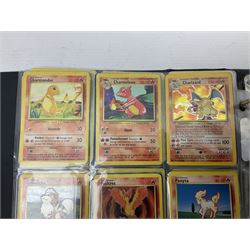Collection of Pokemon trading cards, mostly 1999 Wizards Pokemon cards to include holo Charizard 4/102, first edition holo Machamp 8/102, further holographic cards; Dark Flareon 35/82 and Dark Vaporeon 45/82, cards from themed sets and 4th edition prints; 1998 Electronic Pokédex with cardboard boxes for themed decks Blackout, Overgrowth and Power Reserve Jungle, along with a large quantity of energy and trainer cards 