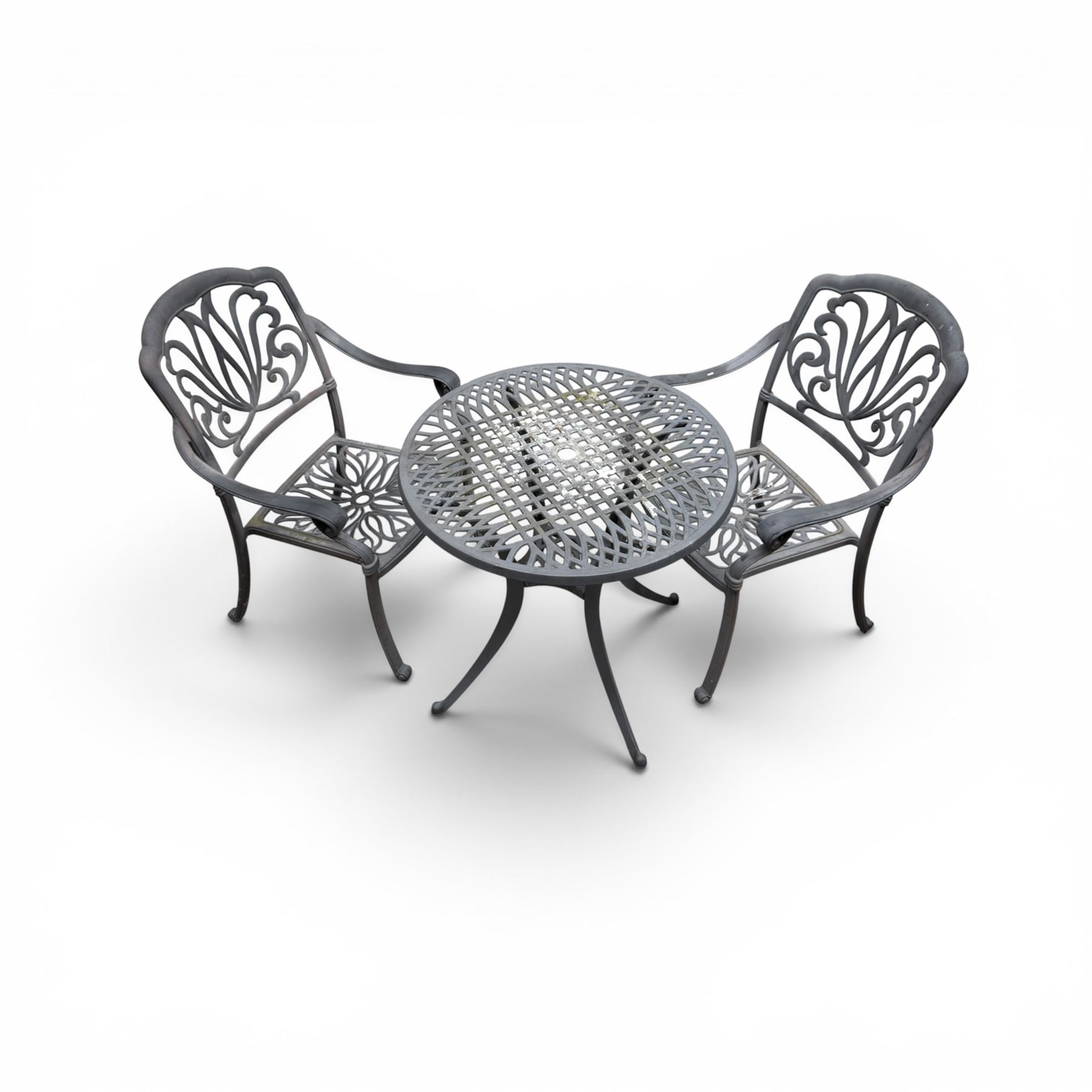 Circular aluminium garden table and pair of armchairs chairs with a pierced and scrolling backs 
