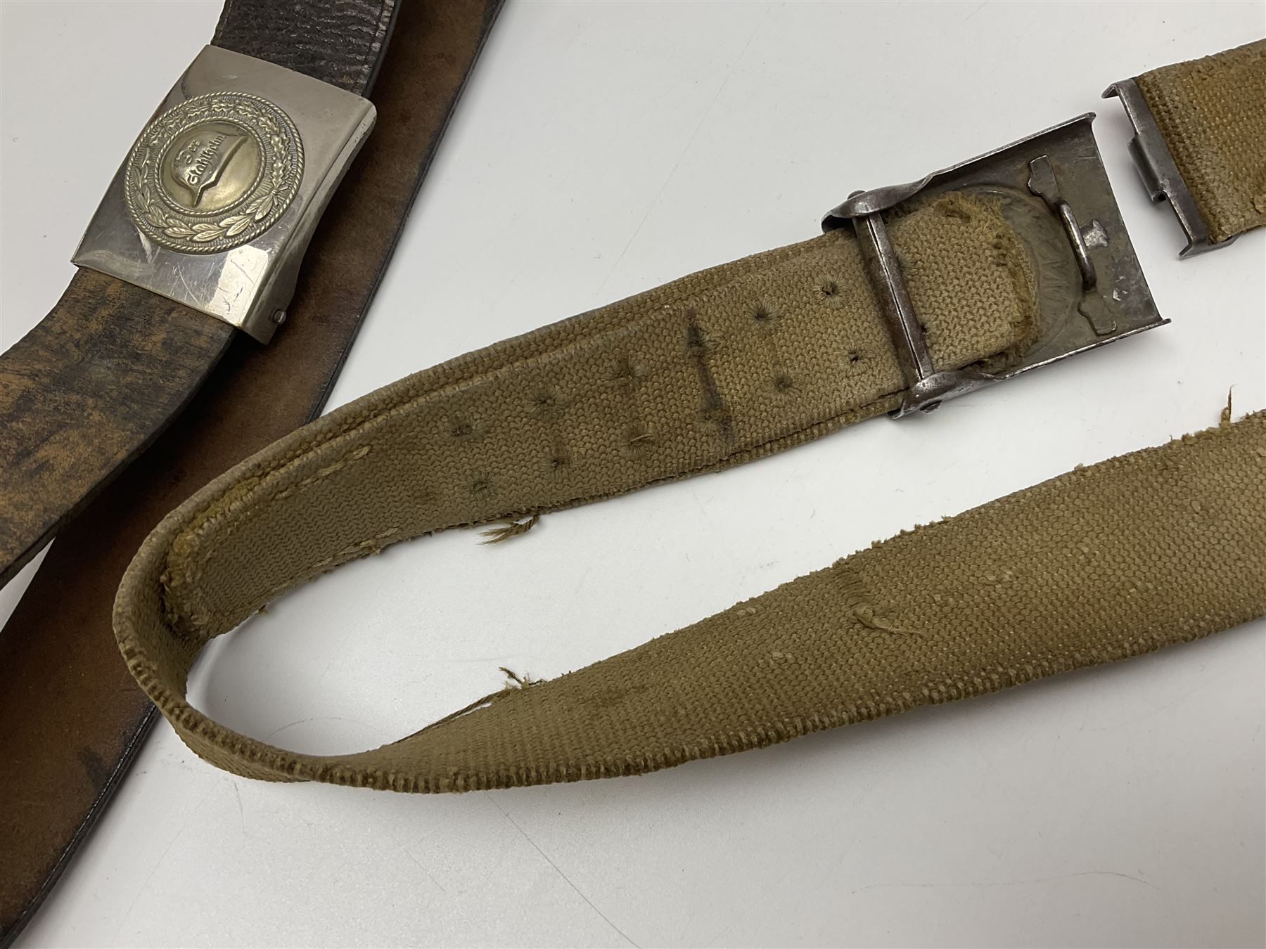 Pair of WW2 German Other Ranks trousers c1940-42, stamped C.& A. Brenninkmeyer Workstatten; WW2 German Army webbing belt with steel 'Gott Mit Uns' buckle; and WW2 German leather belt with 'Stahlhelm' (Steel Helmet League) members buckle (3)