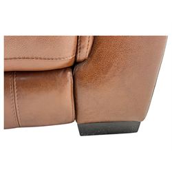 DFS - 'Liaison' reclining armchair upholstered in brown leather, upholstered in tan leather with stitched panel backrest and generously cushioned seat and arms, operated by wired remote, raised on block feet