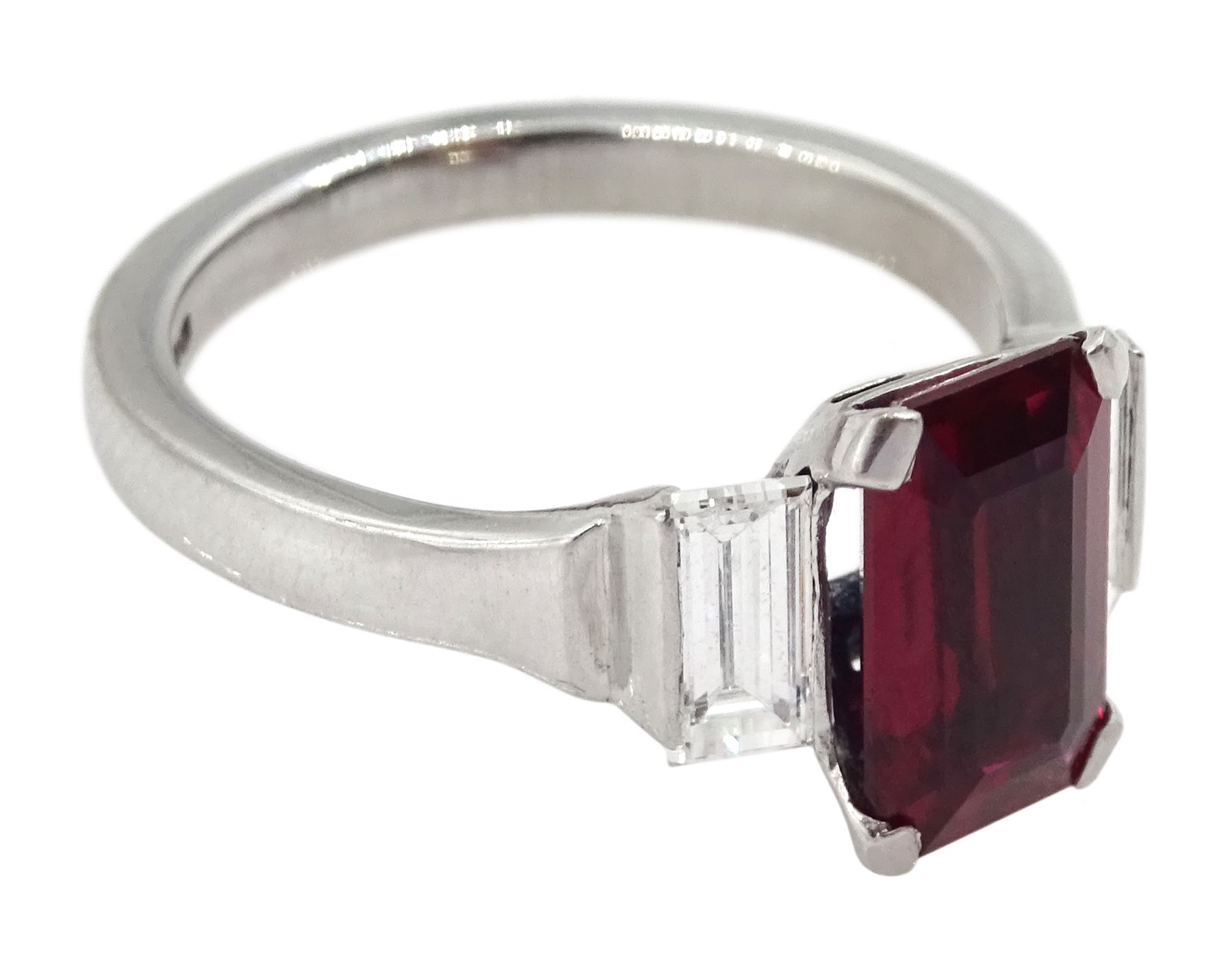 18ct white gold ruby and diamond three stone ring, single emerald cut Thai ruby of approx 2.00 carat, with a baguette cut diamond set either side, hallmarked, total diamond weight approx 0.60 carat