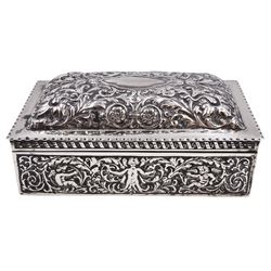 Victorian silver mounted cigarette box, of rectangular form, repousse decorated with ornate putti, floral, foliate and scroll detail, with a central blank cartouche to slightly domed, hinged cover, opening to reveal softwood lined compartmentalised interior,  hallmarked London 1888, maker's mark indistinct, H7cm