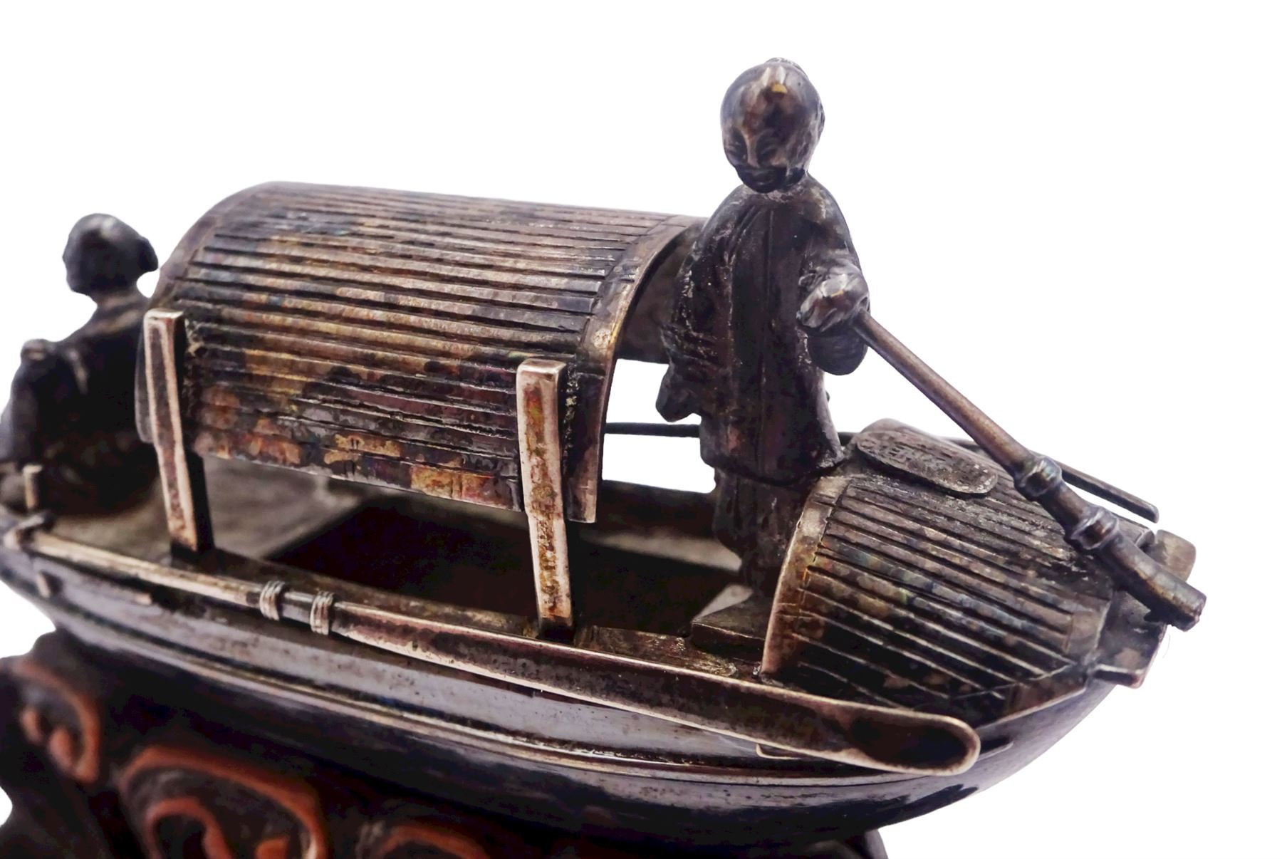 Chinese miniature silver model of a junk, with character mark to stern, mounted upon a carved wooden stand, overall H5cm L6.5cm