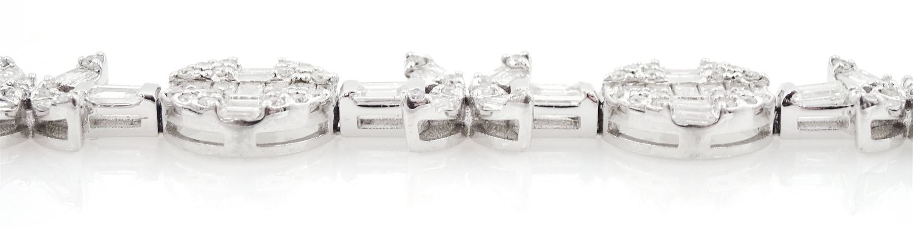 18ct white gold diamond bracelet, eight circular, pave set round brilliant cut and baguette cut diamond clusters, spaced by a single baguette cut diamond and a diamond flower head design cluster, stamped 750, total diamond weight approx 3.70 carat