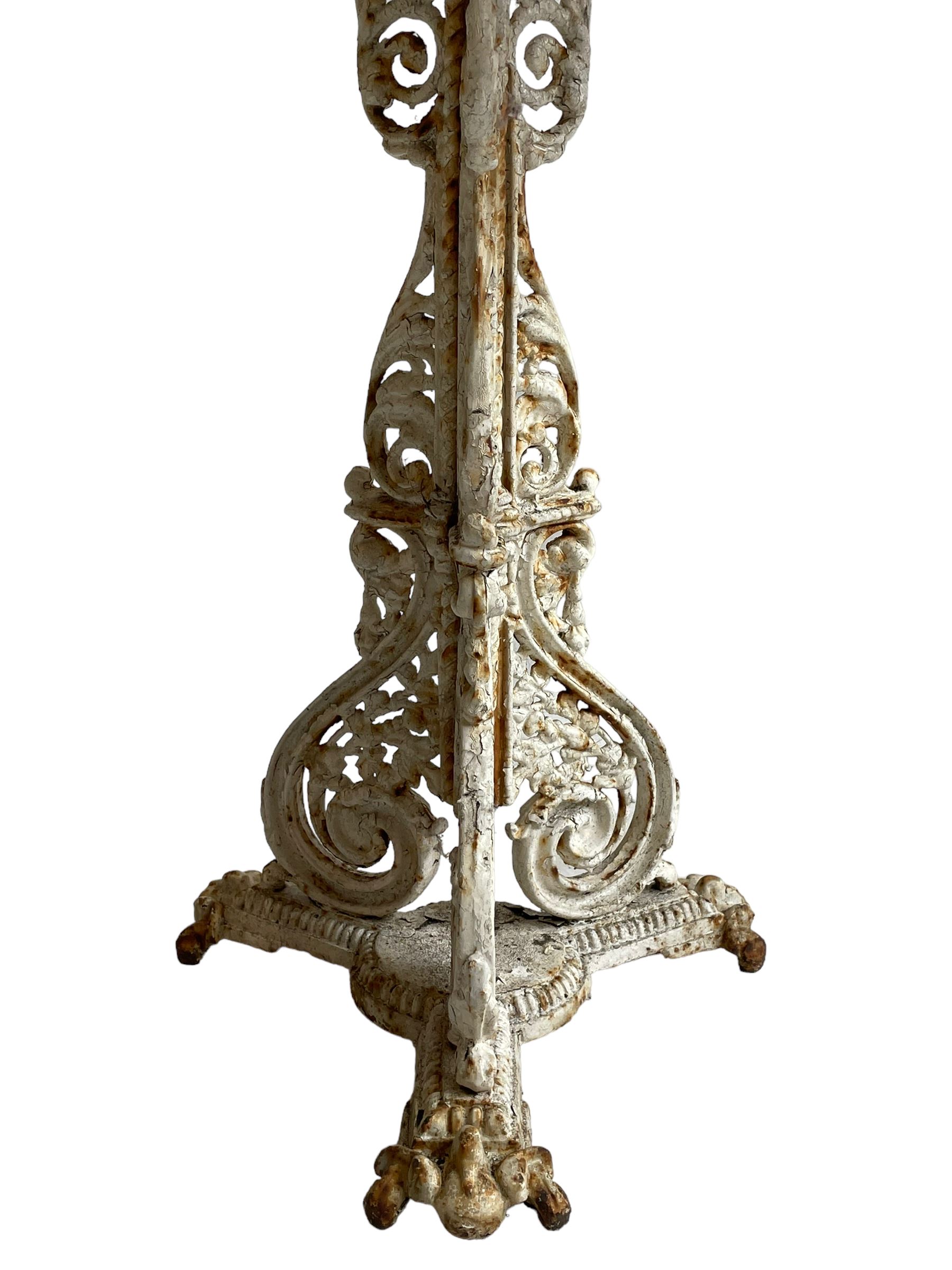 Coalbrookdale design - 19th century cast iron and cast alloy garden table, circular top with beaded edge pierced with scrolls, the pedestal decorated with scrolling and foliate motifs triple arm platform bass with scrolled feet