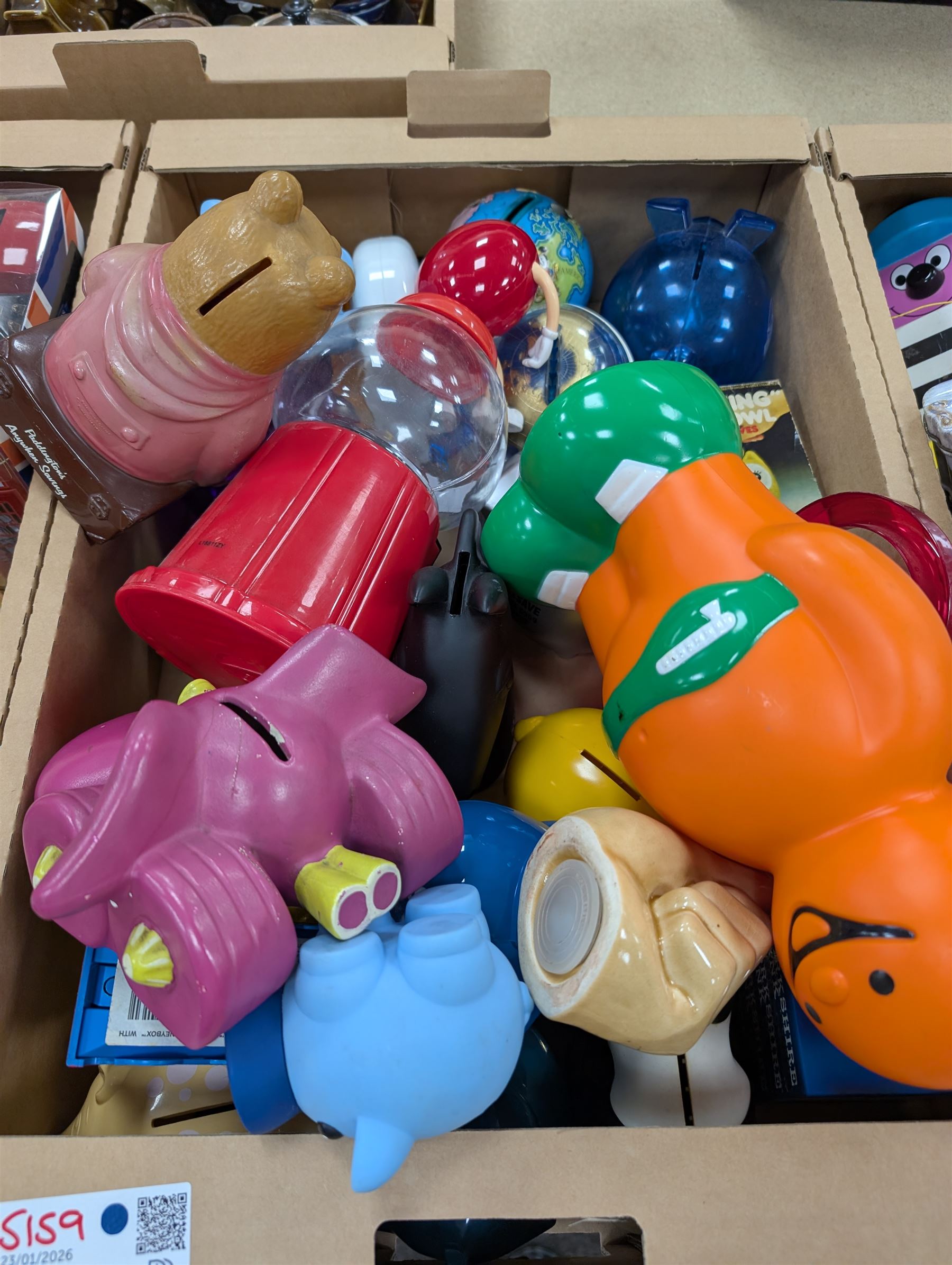 Large collection of vintage money boxes and charity boxes, including plastic, wooden, tin and ceramic examples, of various designs including Paddington, Dunlop, Jellybabies, Meerkat, Halifax Houses, Pigs, etc