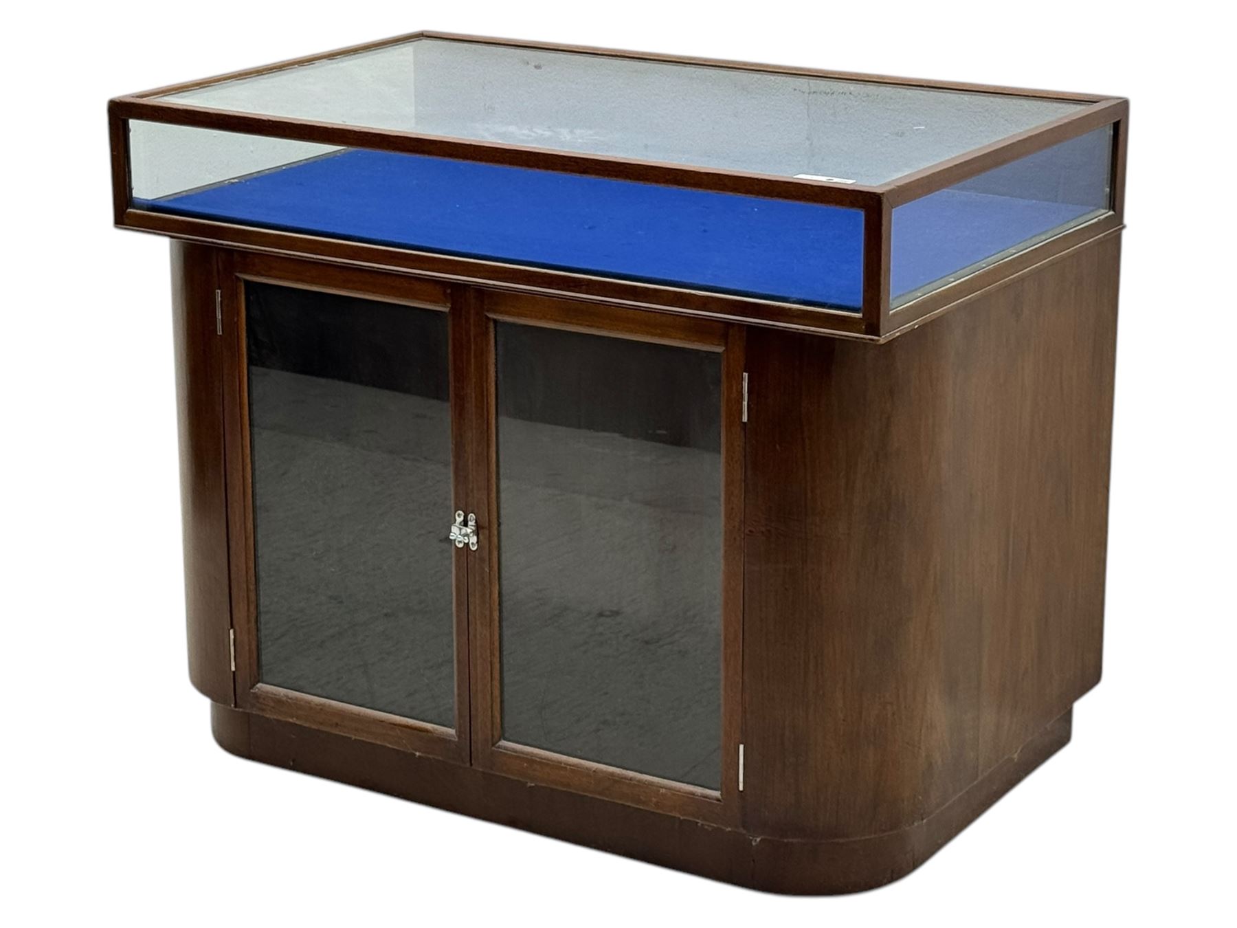 Edwardian inlaid mahogany display cabinet fitted with two glazed cupboards, fitted with rectangular glazed top and sides over a blue velvet interior, twin glazed doors below enclosing a shelved interior on a curved plinth