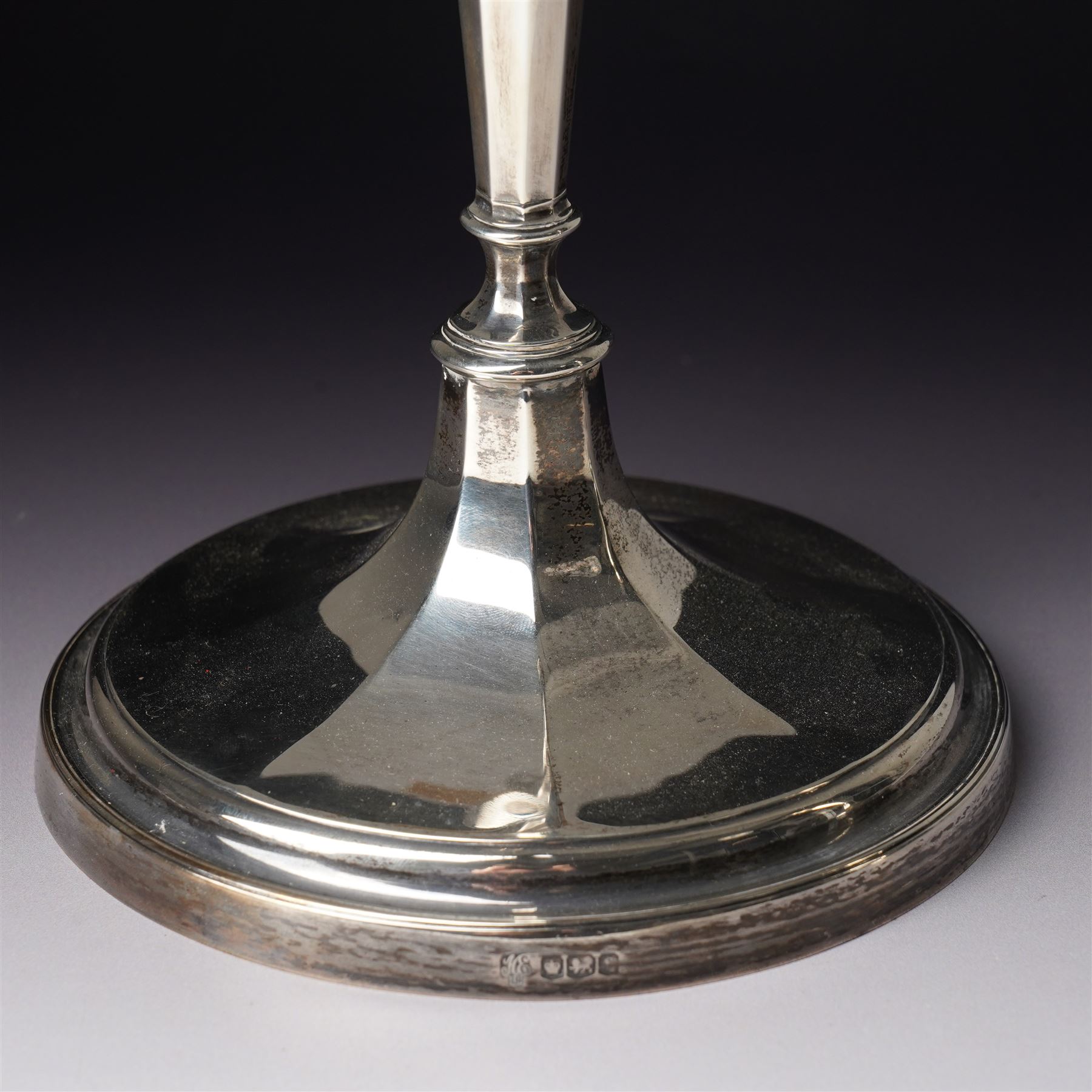 Pair of silver candlesticks with octagonal tapering stems and circular weighted bases H30cm Sheffield 1923 Maker Hawksworth Eyre & Co Ltd