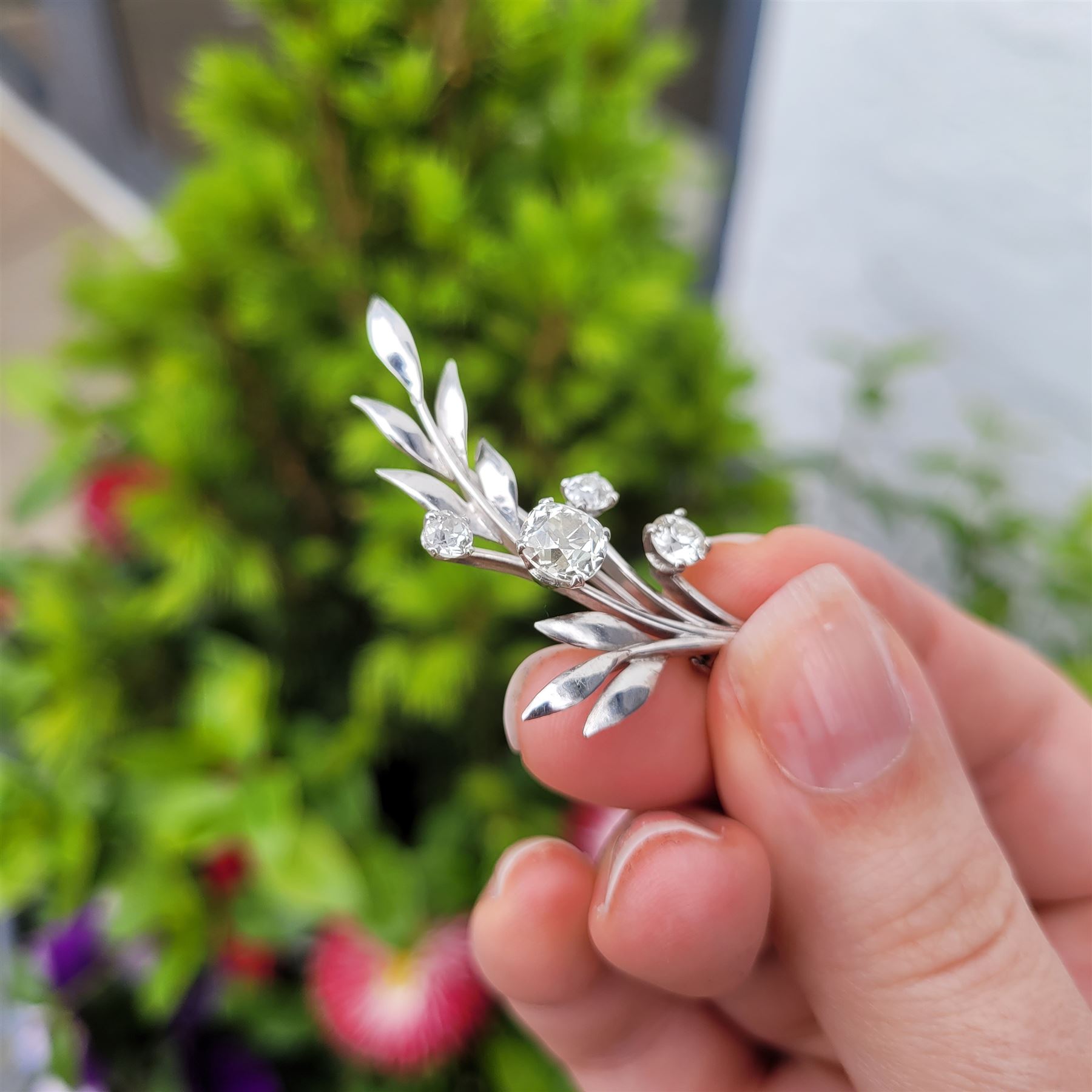 18ct white gold diamond flower brooch, set with a principal old cut diamond of approx 1.00 carat, surrounded by three further old cut diamonds, total diamond weight approx 1.75 carat