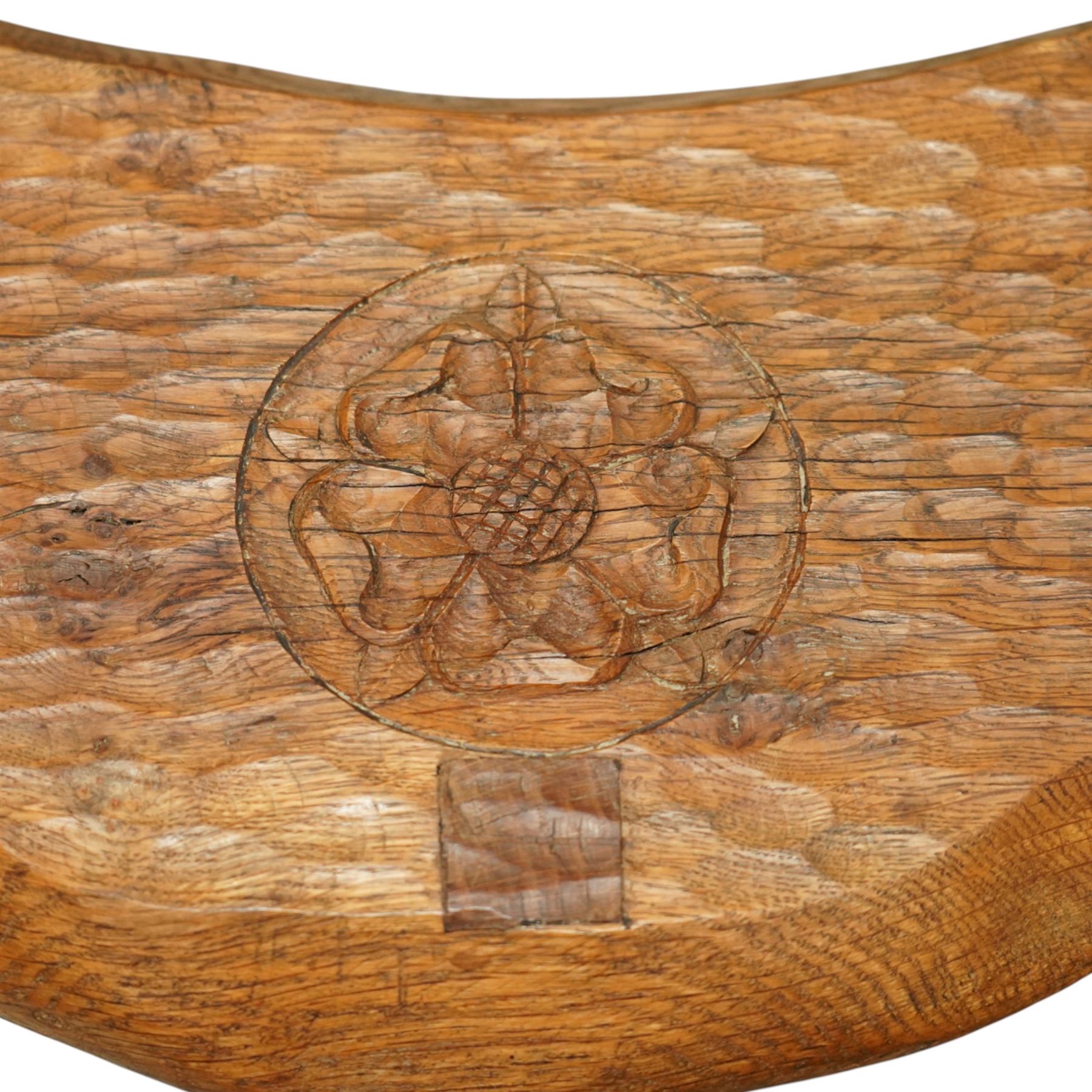 Gnomeman - oak Yorkshire rose milking stool, adzed surface with carving of a Yorkshire rose, exposed wedged through tenons, square legs with chamfered edges, with signature carving of a Gnome, by Thomas Whittaker of Littlebeck