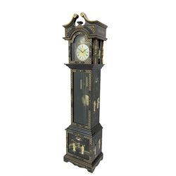 20th century 8-day chain driven black lacquered longcase clock - with a swans neck pediment and break-arch hood door, fully glazed trunk door displaying brass cased weights and pendulum, case sides, hood and plinth profusely decorated in gold relief and chinoiserie figures, brass break arch dial with an etched centre and silvered chapter ring, German two train movement striking the hours and half hours on two gong rods. With weights and pendulum.
