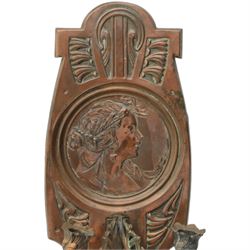 Pair of late 19th/early 20th century Art Nouveau copper twin branch wall sconces, each with shaped back plate chased with a central panel of a maiden in profile above and surmounted by foliate motifs, supporting two foliate open cast branches with bud sockets above conforming drip pans, H31cm W16cm D8.5cm
