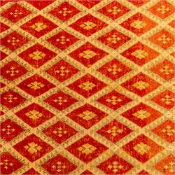 Moroccan Berber hand knotted runner, the red and orange ground woven with an all over lattice of lozenge motifs enclosing small geometric devices, within narrow patterned borders, finished with fringe to one end