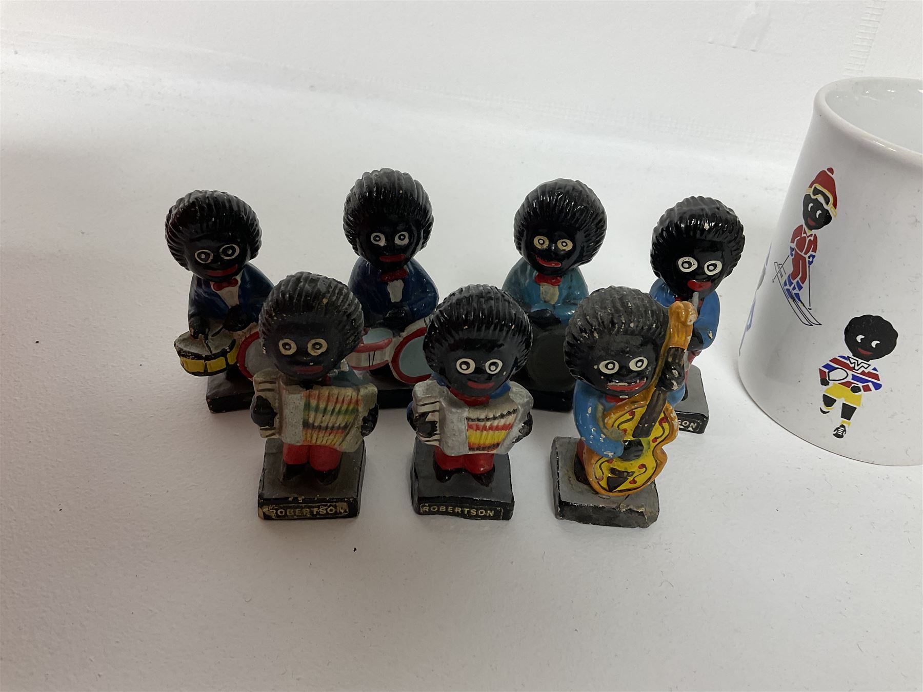 Fourteen Golly Band figures, eight labelled Robertson to base, and TAMS golly mug