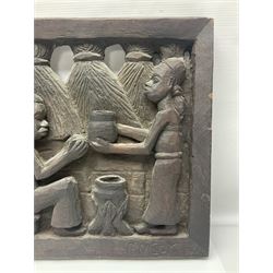 Carved African wall plaque, depicting a village, signed P.Ngoy, H34cm, L114cm