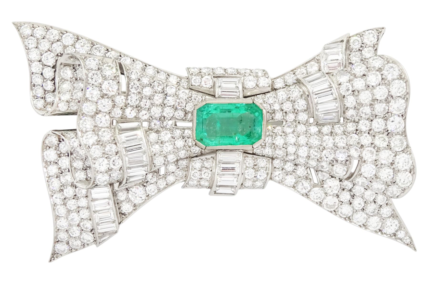 Platinum emerald and diamond bow brooch, central octagonal cut emerald of approx 4.00 carat, with round brilliant and baguette cut diamond surround, total diamond weight approx 23.00 carat