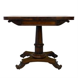William IV rosewood card table, rounded rectangular swivel and fold-over top with plain frieze, with carved scrolled brackets above stop-fluted column with moulded collar on quadriform base with scrolled feet 