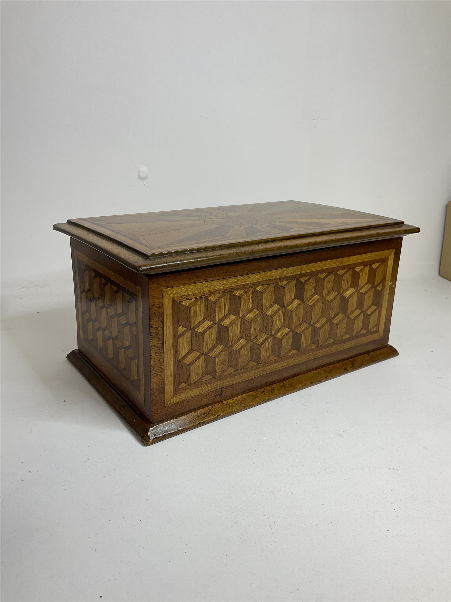 19th Century mahogany and parquetry box of rectangular form, geometric cube design, with a stylised sun detail to the hinged cover, opening to reveal three compartments, L33cm D21cm H16cm
