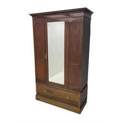 Edwardian inlaid mahogany wardrobe, projecting moulded cornice over central bevelled mirror glazed door, panelled uprights inlaid with trailing bellflowers and foliate decoration, the skirted base fitted with single drawer 