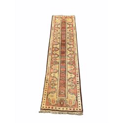 Turkish runner, pale red and yellow ground, the field decorated with stylised star motifs