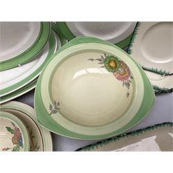 Clarice Cliff for Newport Pottery Corolla pattern tea and dinner wares, comprising triangular bowl, four side plates, two shallow bowls and teacup (a/f), together with a Clarice Cliff Wilkinson twin handled soup bowl and unassociated saucer both decorated with pink and yellow flowers, together with other mid century ceramics comprising Parrott and Company Coronet Ware, and Royal Staffordshire AJ. Wilkinson Ltd dinner wares