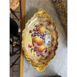 Late 20th century Royal Worcester dish, of oval form with gilt shaped rim and twin shell handles, hand painted by Jason Bowman with still life of fruit upon mossy ground, signed J Bowman, wit marks beneath, with makers fitted card box



