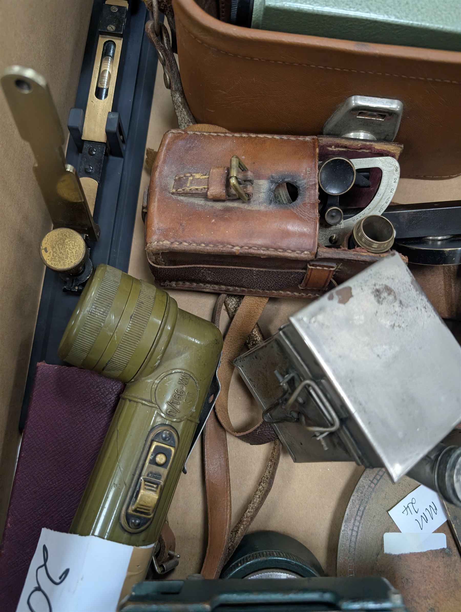 Two dumpy levels including Watts & Son ltd example and a Vickers Instruments example, US Navy bubble sextant, GT Price torch stamped US MX 991/U, 'The Unique' slide rule, three draw telescope and other instruments