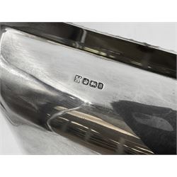 Early 20th century silver entree dish and cover, of rectangular form with shaped corners and oblique gadrooned borders to base and cover, the cover with loop 'bamboo' handle, hallmarked Thomas Bradbury & Sons Ltd, Sheffield 1930, including handle H10.5cm L24.5cm