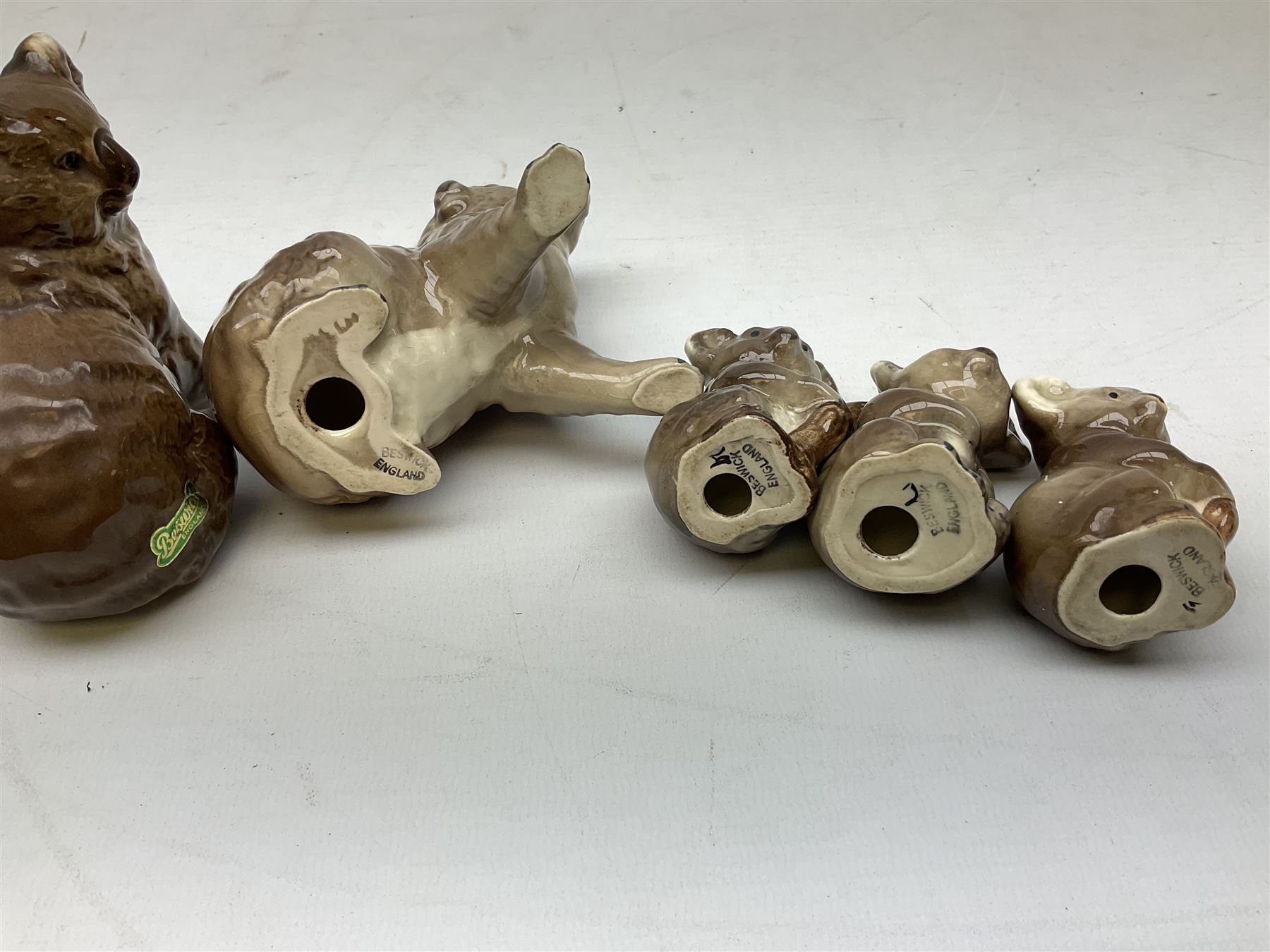 Five Beswick Koala bears, comprising two large koalas no.1038, koala on branch no. 1039 and baby koala no.1040