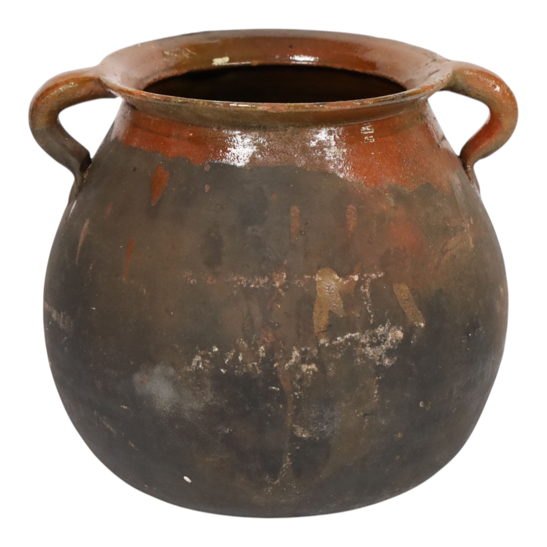 Three early 20th century Spanish part glazed terracotta storage vessels, the first example of bellied form with rounded base and twin loop handles, H24cm, the second of baluster for with close set loop handles, H30cm, and the third smaller also of baluster form with single loop handle, H24cm