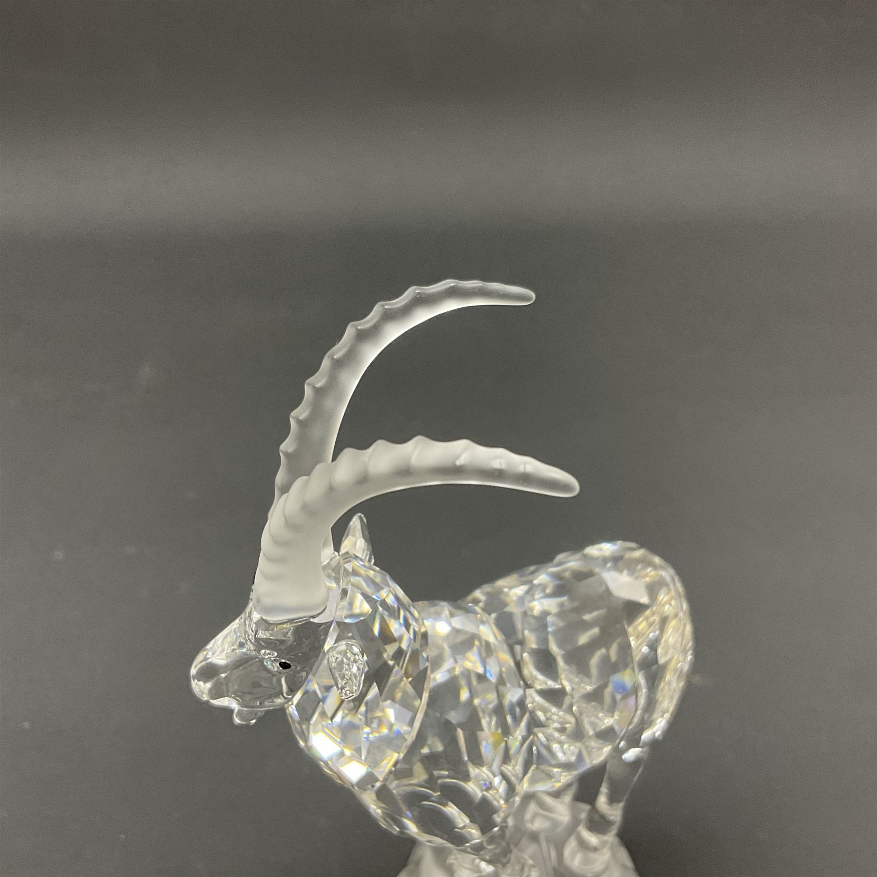 Swarovski Crystal animals, comprising white peacock, the tail with cascading blue flowers, perched eagle with yellow beak, ibex with frosted crystal horns and unicorn with frosted crystal horn, tallest H13cm