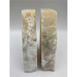 Pair of honey onyx bookends of rectangular form with polished to three sides with a raw outer edge, H18cm 