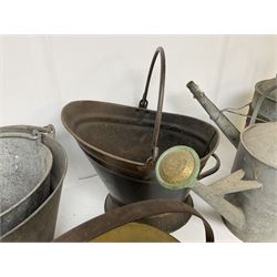 Two vintage galvanised watering cans, three galvanised buckets and a brass jam pan