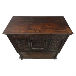 19th century oak cupboard cabinet, the moulded rectangular top above a deeply carved front carved with frieze of lunettes above a central panelled cupboard door with lozenge and foliate carving, flanked by vertical carved panels, upon turned legs with boarded lower shelf