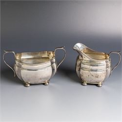 1930s silver three piece tea service, comprising teapot, milk jug and open sucrier, of oval form, the teapot with ebonised handle and finial, hallmarked S Blanckensee & Son Ltd, Chester 1931