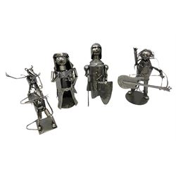 Metal novelty wine bottle holders and covers, to include a rock star with a guitar, hippie, knight, etc (4)