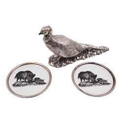 Pair of German plates, each with transfer printed wild boar decoration and silver rims, together with a silver filled model of a pheasant after Genty, hallmarked