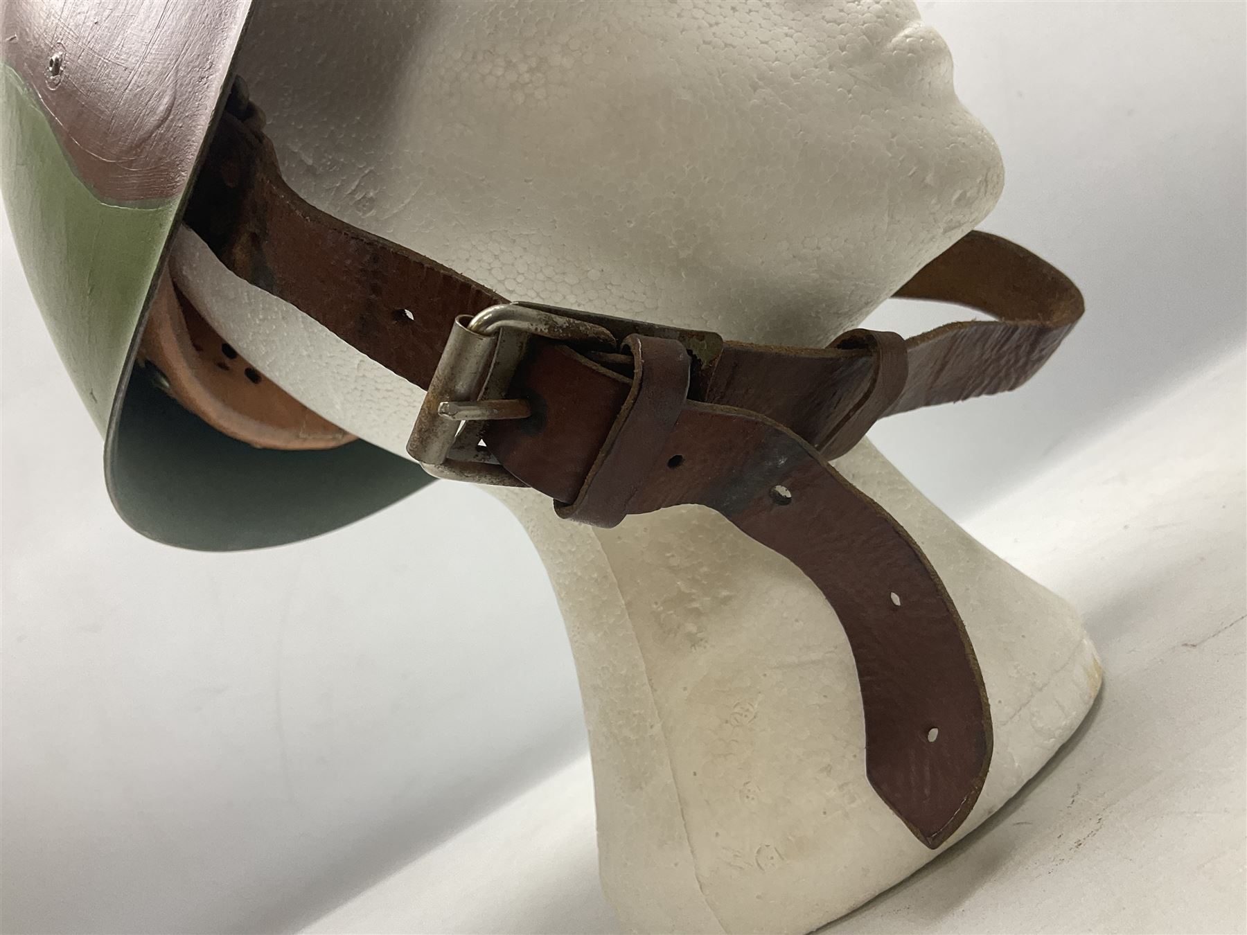 1960s Italian parachutist helmet with liner; camouflage paintwork with parachutist crest to the front