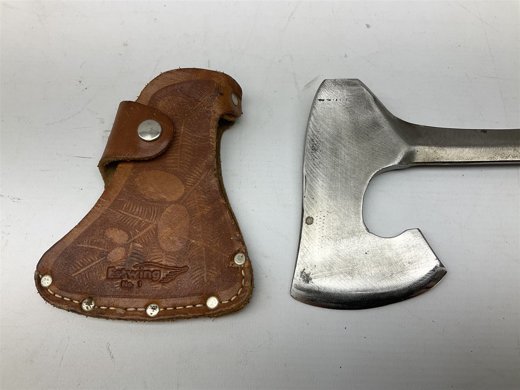 Estwing Black Eagle style double bit throwing axe with leather grip, virtually mint with labels present, plastic blade protectors and nylon sheath L43cm; another smaller Estwing axe stamped 24A to the pommel, with leather grip and sheath; and a vintage short handled hedge knife, the blade stamped IH (?) No.2 (3)