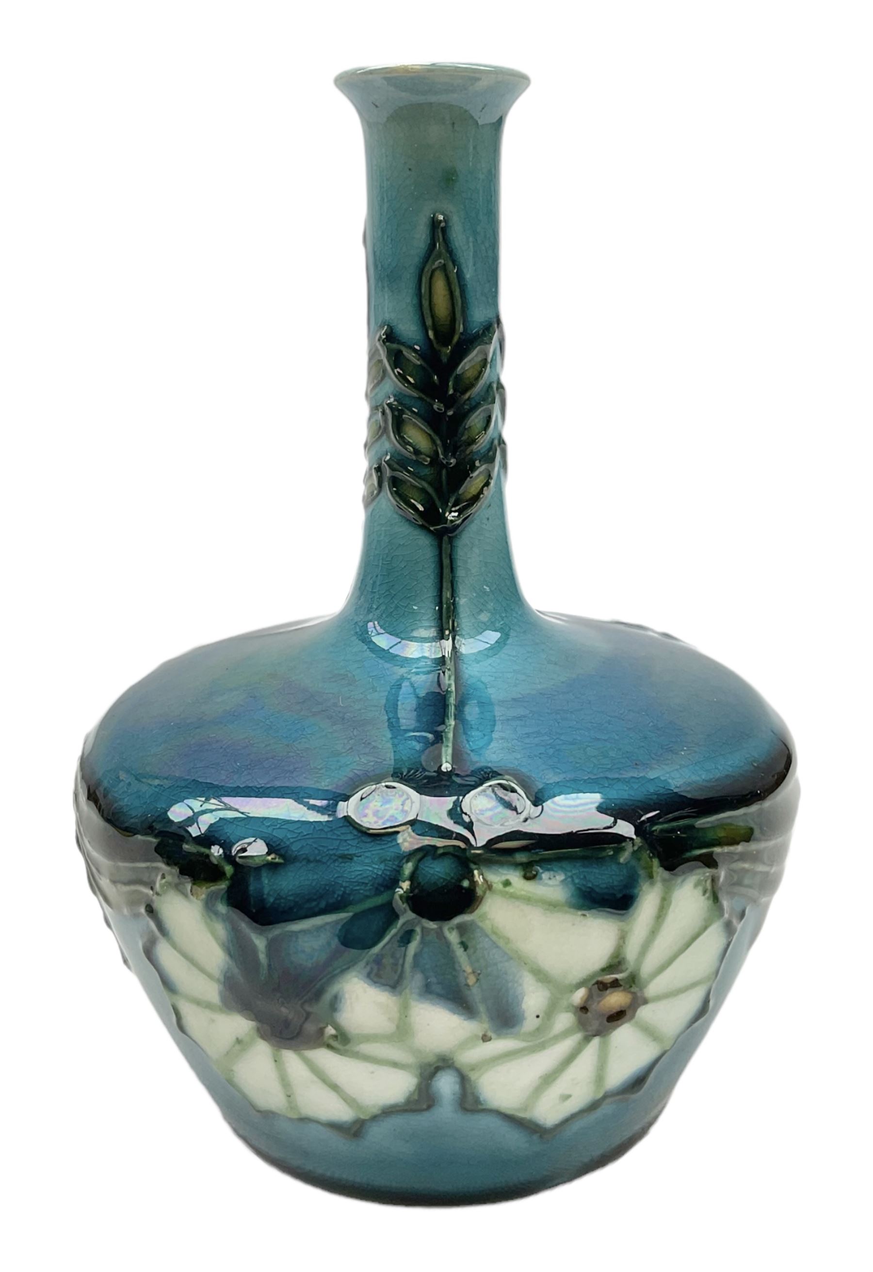 Minton Secessionist vase, with tube-lined stylised flower decoration, upon a blue ground, with printed mark to base 'Minton Ltd, No. 32', H13cm