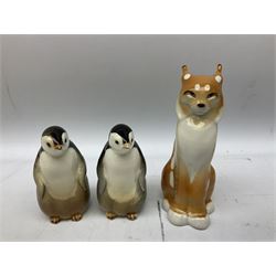 Collection of ceramic USSR animal figures, comprising lynx, two penguins and two raccoons, all with stamped marks beneath, tallest H21cm